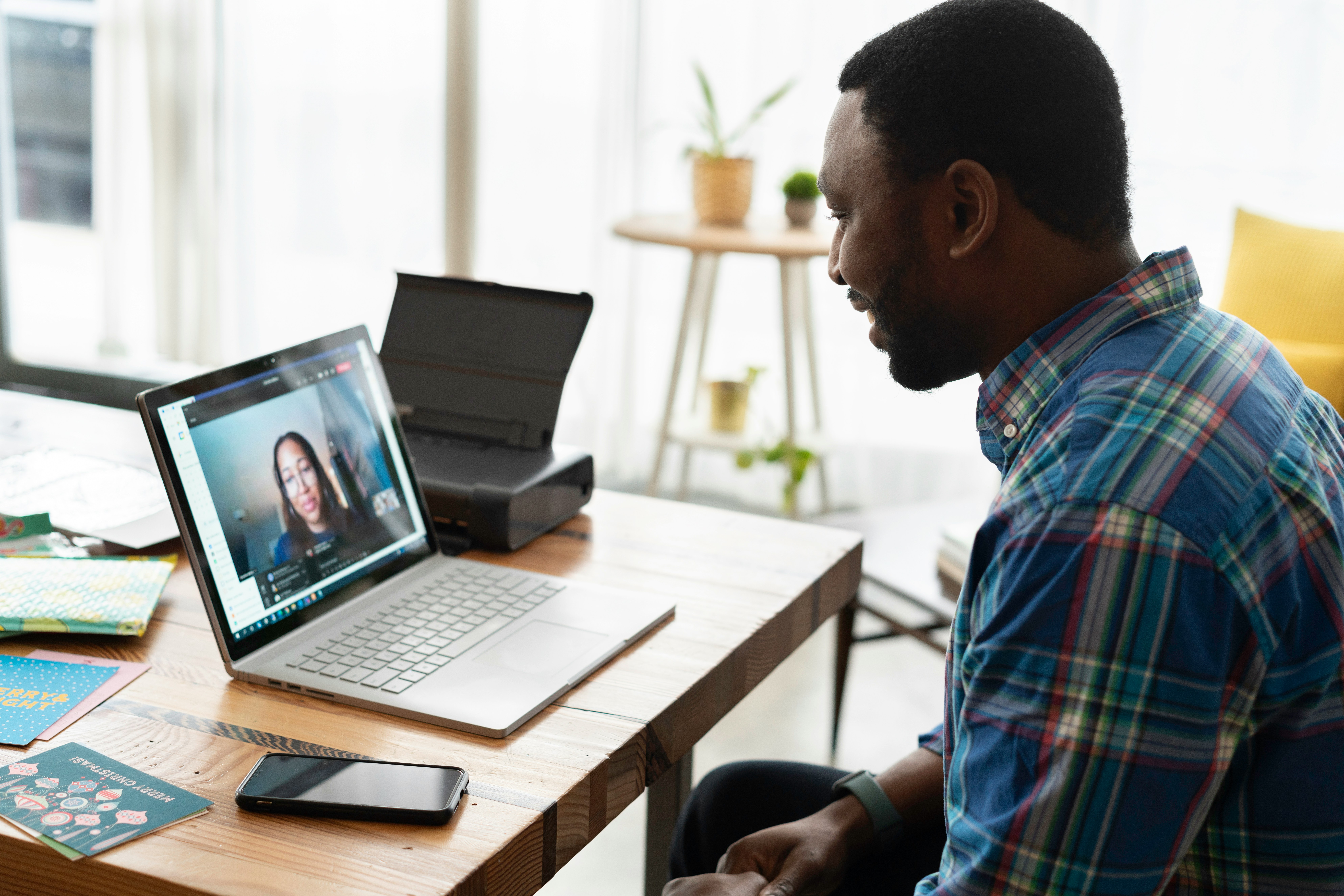 A small business owner on a video call at a home-office desk